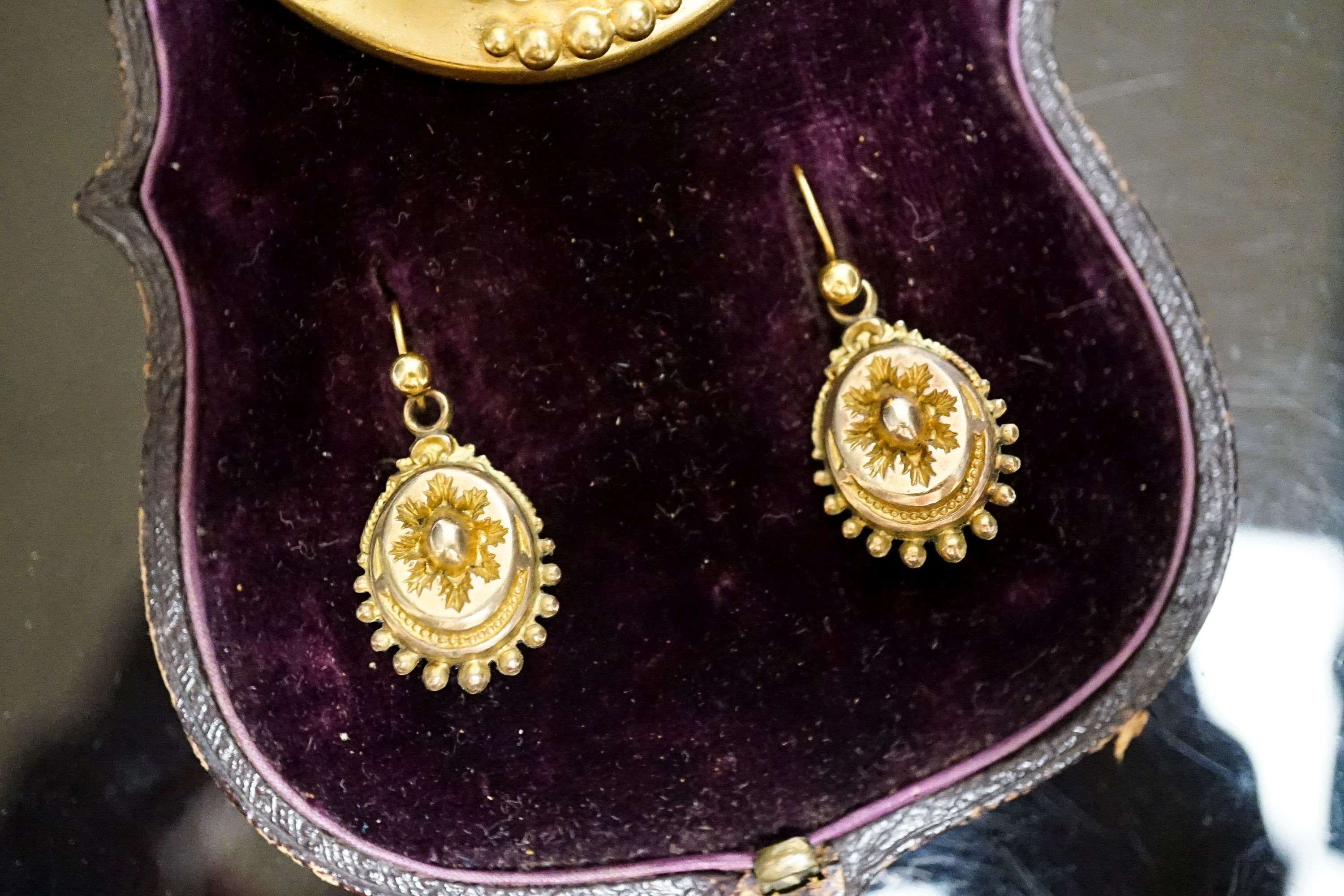 A Victorian yellow metal navette shaped brooch, with bead decoration, 46mm and a pair of similar drop earrings, 22mm, gross weight 17 grams.